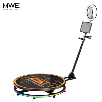 An MWE 360 Photo Booth is shown with its platform, camera arm, light, and device mount.
